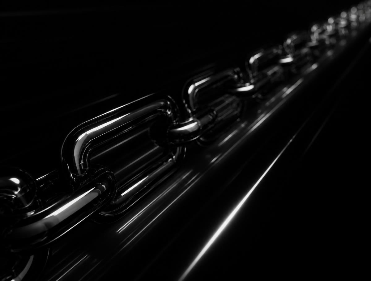 A chain of polished black links receding into darkness